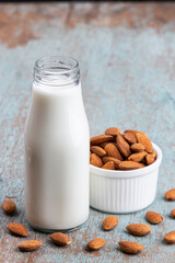 Almond milk with Almond seeds. Almond milk in a bottle with almonds