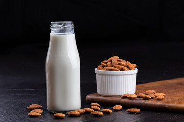 Almond milk with Almond seeds. Almond milk in a bottle with almonds
