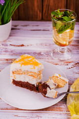 chocolate cake on a wooden table 
against the background of a glass of tea with lemon
yellow cream cake
beautiful chocolate lemon cake on a white table