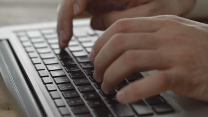 Fototapeta na wymiar Female hands typing on a laptop keyboard