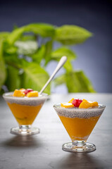 healthy mango dessert layered with chia seeds in glasses