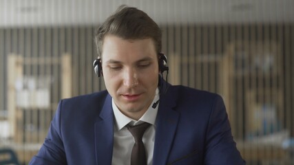 Customer support agent with headphones and microphone in modern office