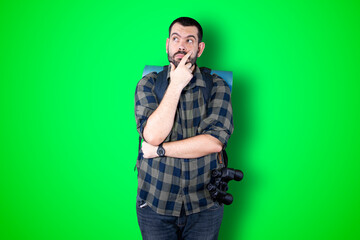 Caucasian handsome traveler man isolated on chroma background thinking an idea while looking up