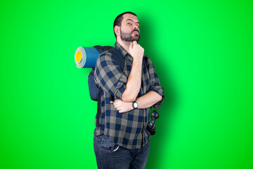 Caucasian handsome traveler man isolated on chroma background thinking an idea while looking up