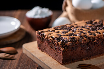 Chocolate flavor Taiwanese traditional sponge cake (Taiwanese castella kasutera) on a wooden tray background table with ingredients, close up.