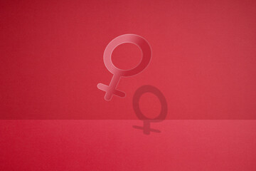 a female gender symbol made by cutting paper.