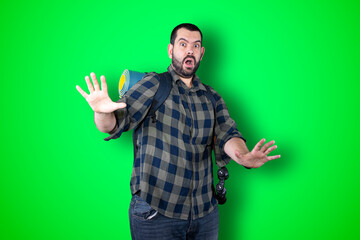 Fototapeta premium Traveler man over isolated chroma background studio with surprise facial expression