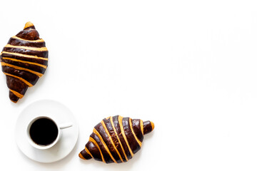 Croissants with coffee - breakfast on white table top view