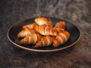 croissants in a ceramic bowl on a dark background vertical image