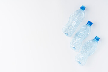 Empty and crushed bottles of water isolated on white background with copyspace. Plastic recycling concept