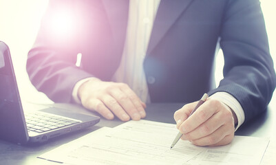 Businessman makes an online transaction. Trading on the exchange via the Internet. Manager works at a laptop in the office.