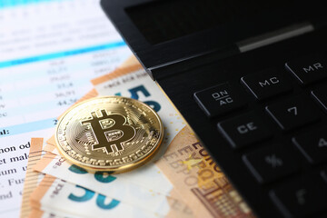 Close up of table with portable electronic device for calculations, euro cash and coin