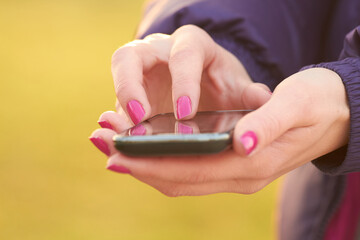 Close-up of female hands holding a modern smartphone.