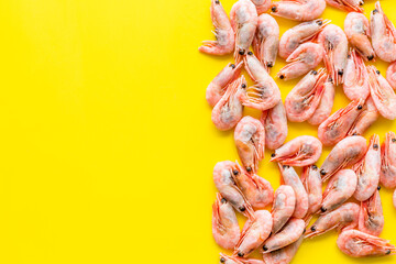 Prawn background on yellow table top view frame copy space