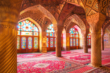 Fototapeta na wymiar Famous pink mosque decorated with mosaic tiles and religious calligraphic scripts from Persian Islamic Quran, Shiraz, Iran. 
