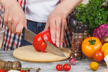 Woman cooks at the kitchen, soft focus background
