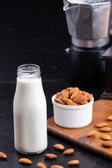 Almond milk with Almond seeds. Almond milk in a bottle with almonds