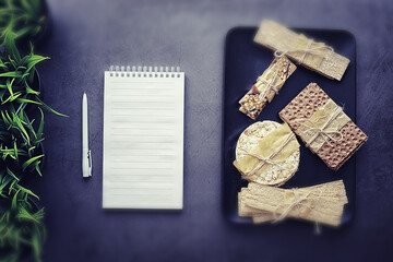 Tilt shift effect.Concept of losing weight and a healthy lifestyle. Bread roll with vegetables and herbs on table.Proper nutrition.Dry bread rolls diet.