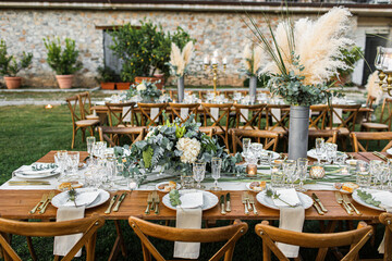 Wedding table set up in boho style with pampas grass and greenery