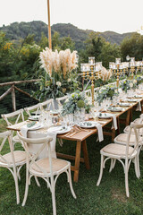 Wedding table set up in boho style with pampas grass and greenery