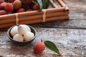 Lychee with leaves on gray background. Tropical fruit.