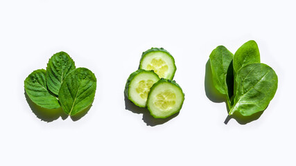 Pattern of fresh green ingredients for salad on white background. Flat lay creative layout of leaves of spinach, mint and cucumber. Healthy eating. Organic and vegetarian food