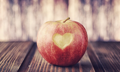 Fresh apples on a wooden board. Harvest of red apples. Fruits and cinnamon on the table.