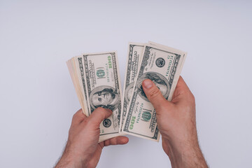 man's hands on a white background count dollars
