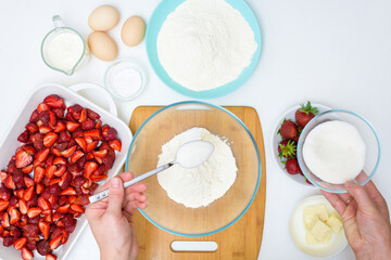step by step recipe strawberry cobbler homemade from ripe fresh strawberries and shortbread on a light background, top view. ingredients for strawberry pie
