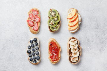 Sweet sandwiches with fruits and berries on white background.