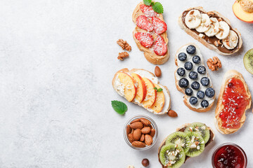 Sweet sandwiches with fruits and berries on white background.