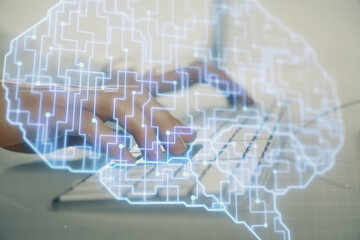 Businessman with computer background with brain theme hologram. Concept of brainstorm. Multi exposure.