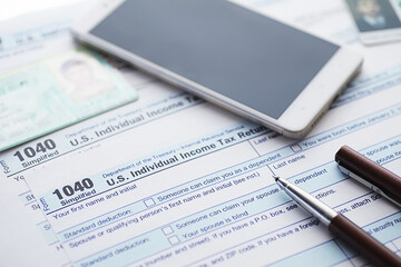 Annual tax reporting. Tax form on the table. Financial statements for signature.