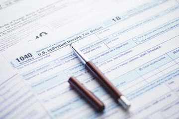 Annual tax reporting. Tax form on the table. Financial statements for signature.