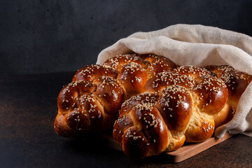 Homemade Challah bread with white cover, Jewish cuisine. Main ingredients are eggs, white flour,...