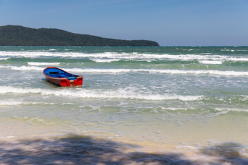 Fototapeta premium Boat on the beach, saracen bay beach, koh rong samloem island, sihanoukville, Cambodia.