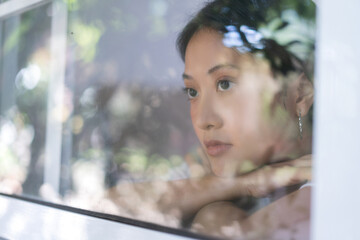 Asian women are lonely and alone. She looks out the house