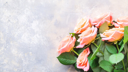 Bouquet of fresh roses on a stucco background. copy space
