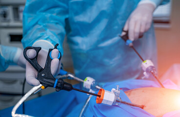 Surgery operation with modern equipment. Selective focus on doctor`s hands with special robotic...