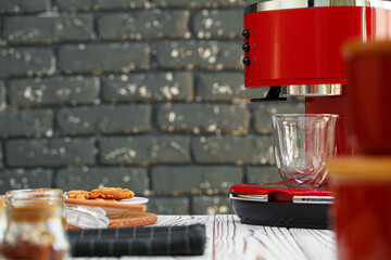 Red coffee machine with a glass on kitchen counter