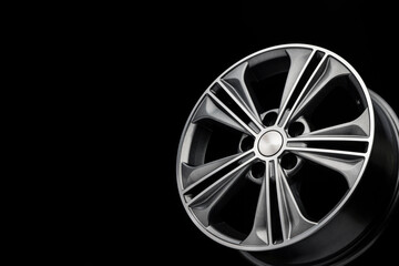 grey beautiful modern aluminum alloy wheel on black background, copy space