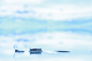 Tools for vision correction. Glasses and lenses with diopters on the background of splashes and...