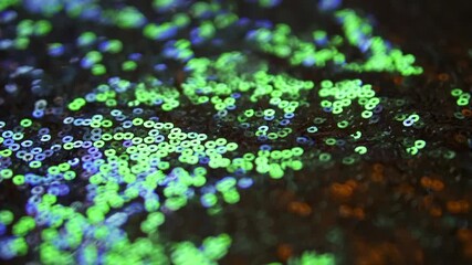 Green sequins. Sparkles on the fabric. High quality FullHD footage - Powered by Adobe