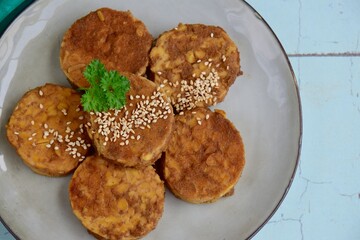 Slices of tempeh (fermented soybean) on the wooden board