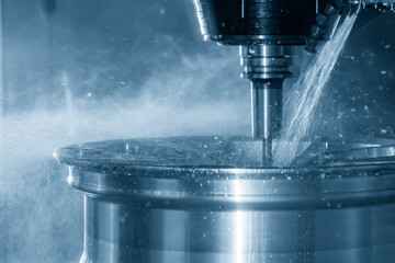 The multi-axis machining center cutting the magnesium alloy wheel by solid end mill tools. The hi-technology automotive parts manufacturing process by CNC milling machine. © Pixel_B