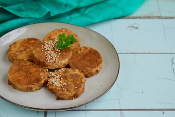 Slices of tempeh (fermented soybean) on the wooden board