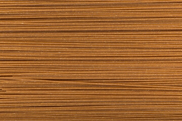 Pasta closeup background. Italian whole grains spaghetti. culinary background