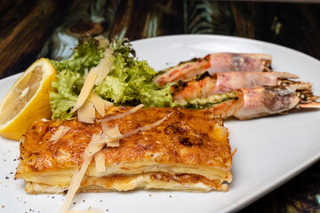 Langoustines with young potatoes. A dish with large king prawns, lobsters with vegetables. Seafood with a panel, a delicious seafood delicacy, a source of omega 3.