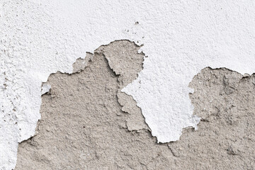 Wall damage on outdoor. Plaster and paint clog, surface damage. Peeled plaster wall background