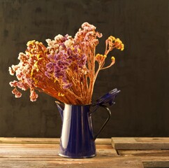 Still life of dried flowers in the evening sun in a barn